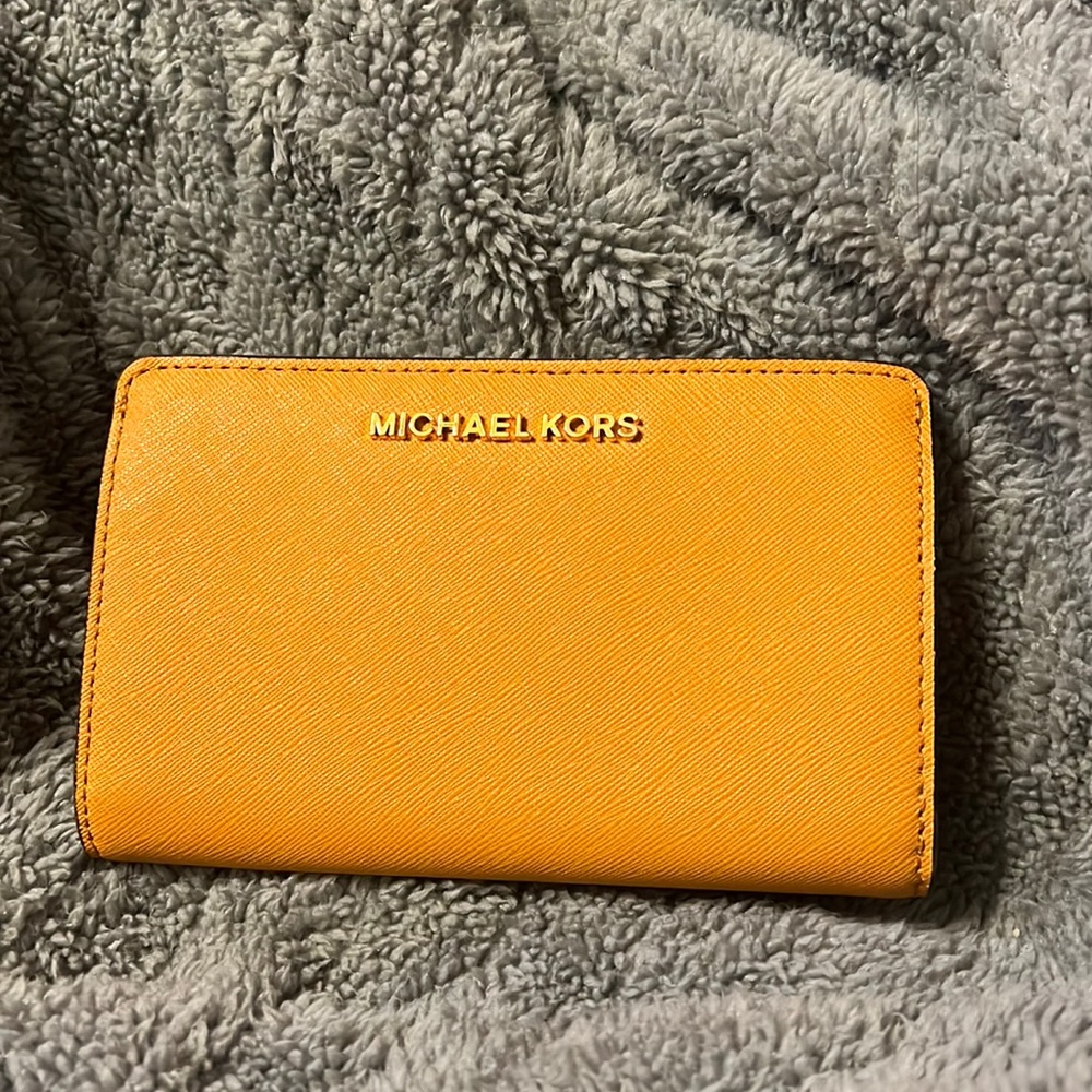 Authentic leather Michael Kors wallet 6.5”x4” in mustard yellow
